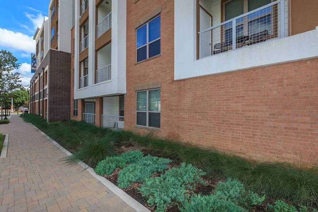 a brick building with a sidewalk in front of it