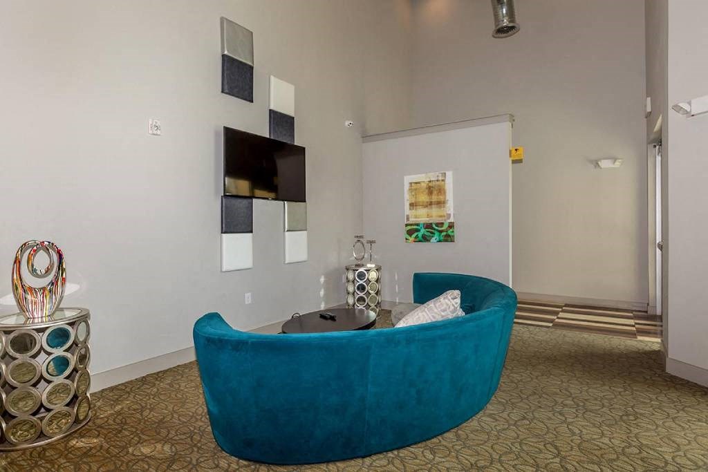 a living room with a blue couch and a television