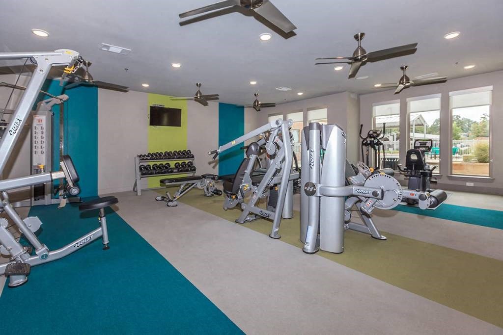 a gym with weights and other equipment in a home for sale