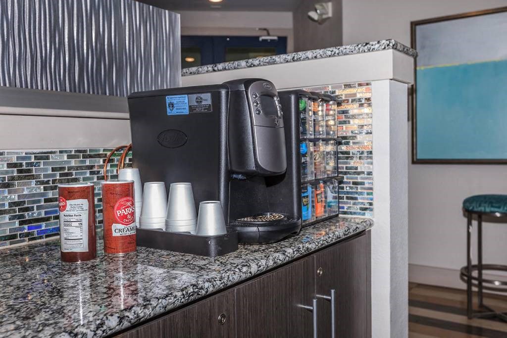 a coffee maker on a counter in a hotel room