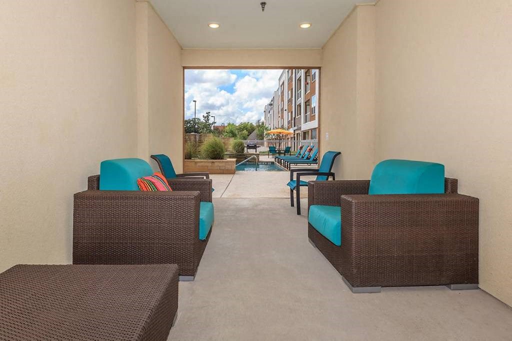 a lobby with chairs and tables and a large window