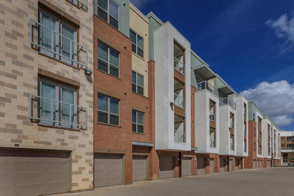 a large brick building with a street in front of it