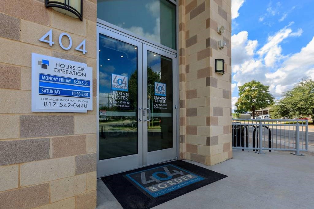 the entrance to the lobby of a building with a lease sign on the door