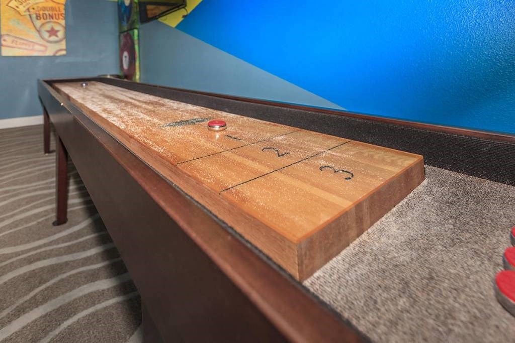 a wooden table with a game of shuffleboard on it