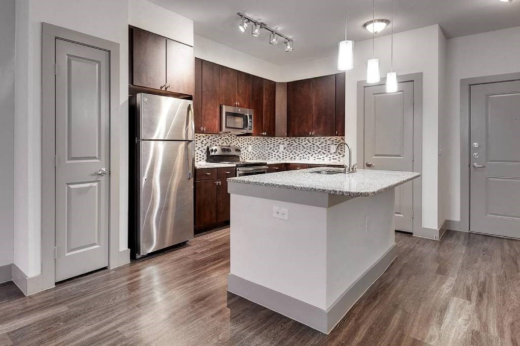 a kitchen with a stainless steel refrigerator and a counter top