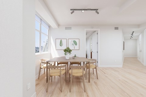 A dining room with a table and chairs.