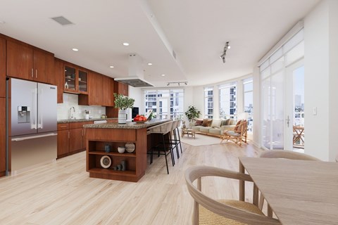 A modern kitchen with wooden cabinets and a marble island.