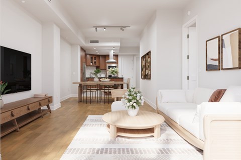 A living room with a white couch and a wooden coffee table.