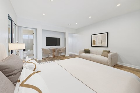 A modern living room with a white sofa and a television.