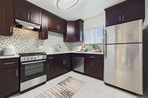 A kitchen with a stove, oven, and refrigerator.