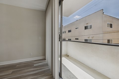 A room with a view of a building across the way.