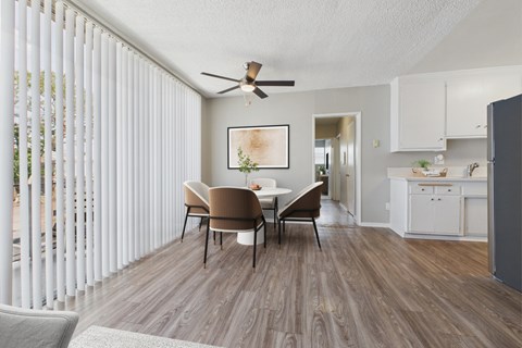 A dining room with a table and chairs.
