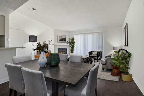 A dining room with a table and chairs.