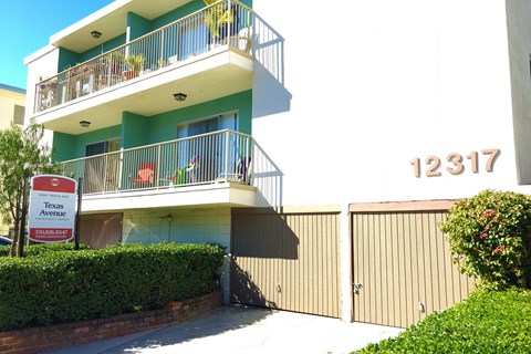 Apartment building with balconies and a sign that says Texas Avenue.