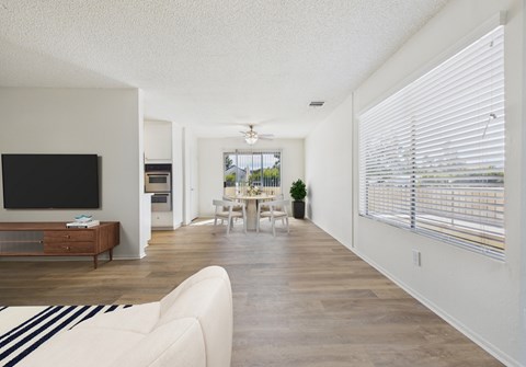 A living room with a white couch and a television.