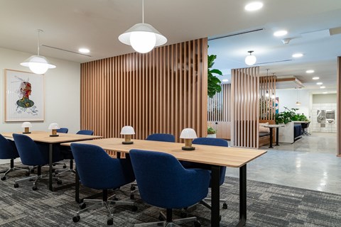 a room filled with blue chairs and tables