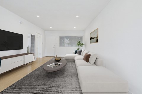 A modern living room with a white sofa and a black rug.