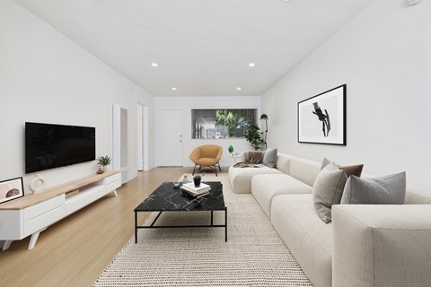 A modern living room with a black coffee table and a large flat screen TV.