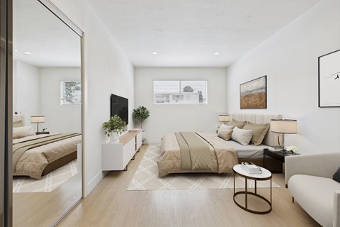 A modern bedroom with two beds and a coffee table.