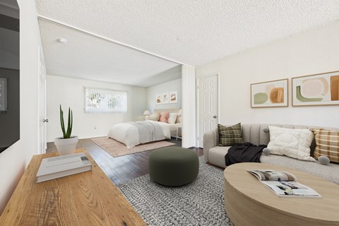 A living room with a grey couch and a green ottoman.