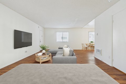 A living room with a grey couch and a wooden coffee table.