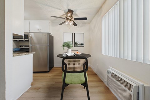 A kitchen with a table and chairs in the middle of the room.