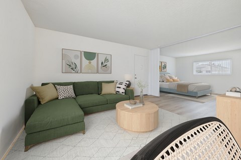 A living room with a green couch and a wooden coffee table.