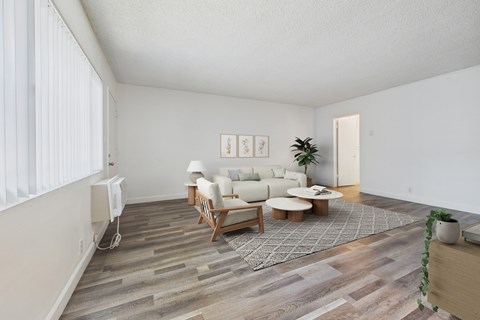 A living room with a white couch and a wooden coffee table.