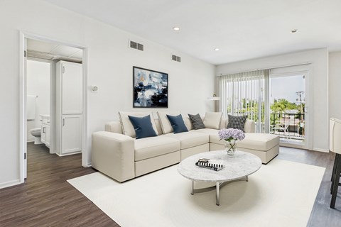A living room with a white couch and a coffee table.