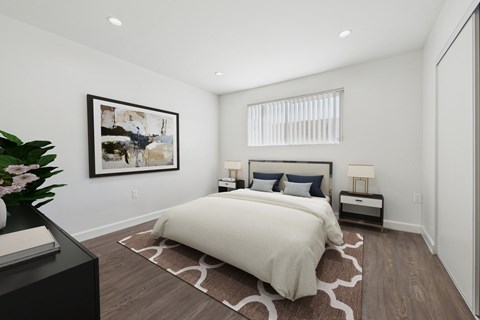 A bedroom with a large bed and a painting on the wall.