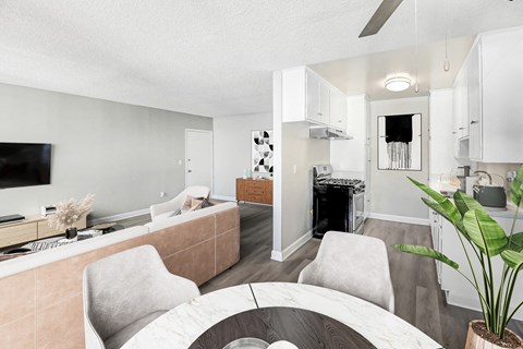 A living room with a grey couch and a white chair.