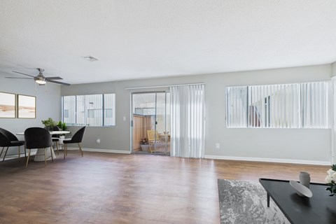 A living room with a dining table and chairs.