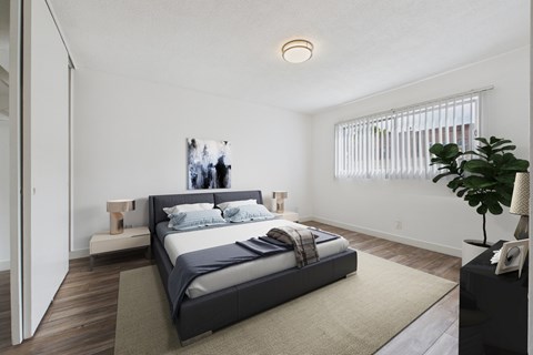 A bedroom with a large bed and a plant on the side table.