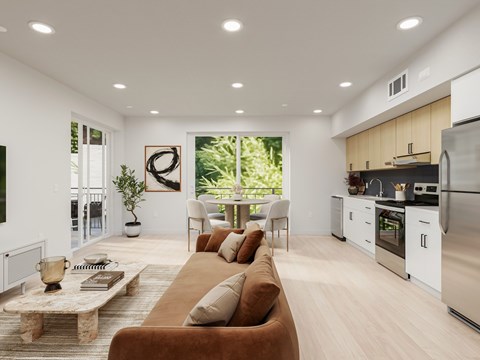 A modern living room with a brown sofa and a kitchen in the background.