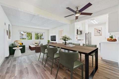 A dining room with a table and chairs.