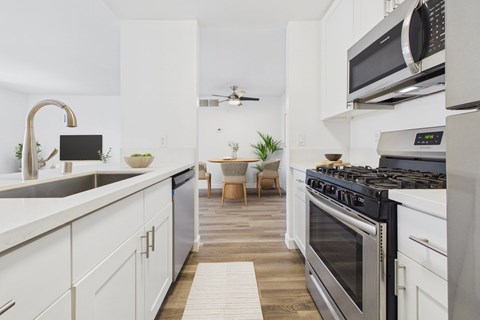 A modern kitchen with a black stove top oven.