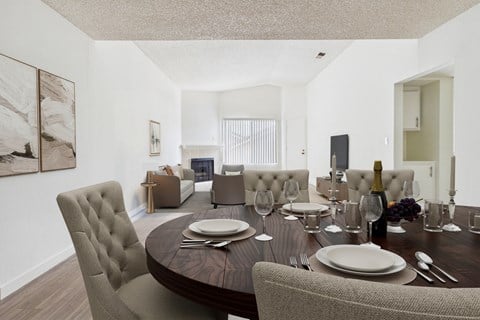 A dining room with a round table set for two.