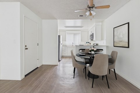 A dining room with a table set for four.