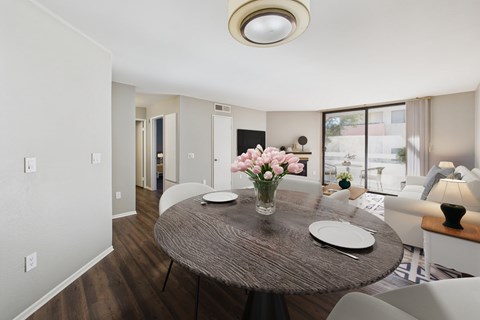 A dining room with a round table and chairs.