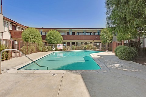 A swimming pool in front of a building.