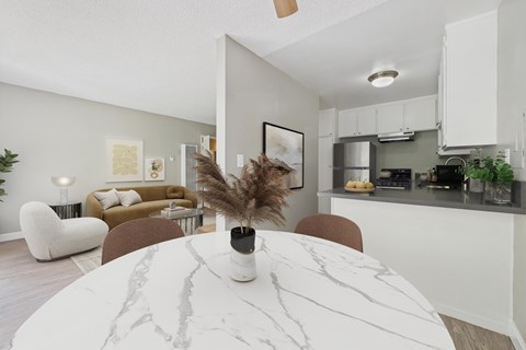 A modern dining room with a marble table and chairs.
