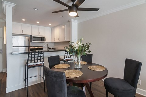 A dining room with a round table and chairs.