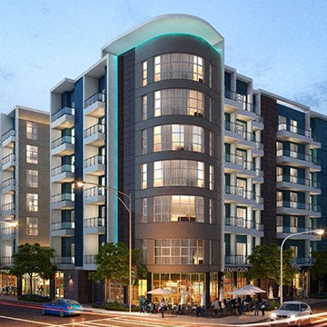 A modern apartment building with a curved glass facade and balconies.