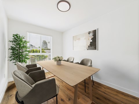 A conference room with a long table and chairs.