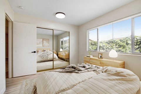 a bedroom with a large bed and a large window
