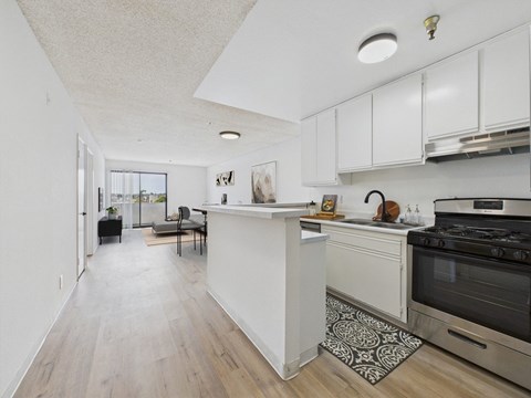 A kitchen with a white counter and a black oven.