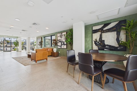 A modern dining room with a table and chairs.