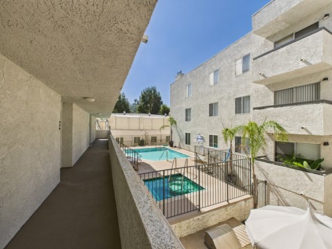 A long hallway with a pool on the other side.