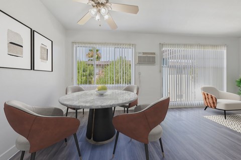 A dining room with a round table and chairs.