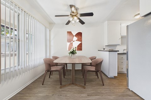 A dining room with a table set for four.